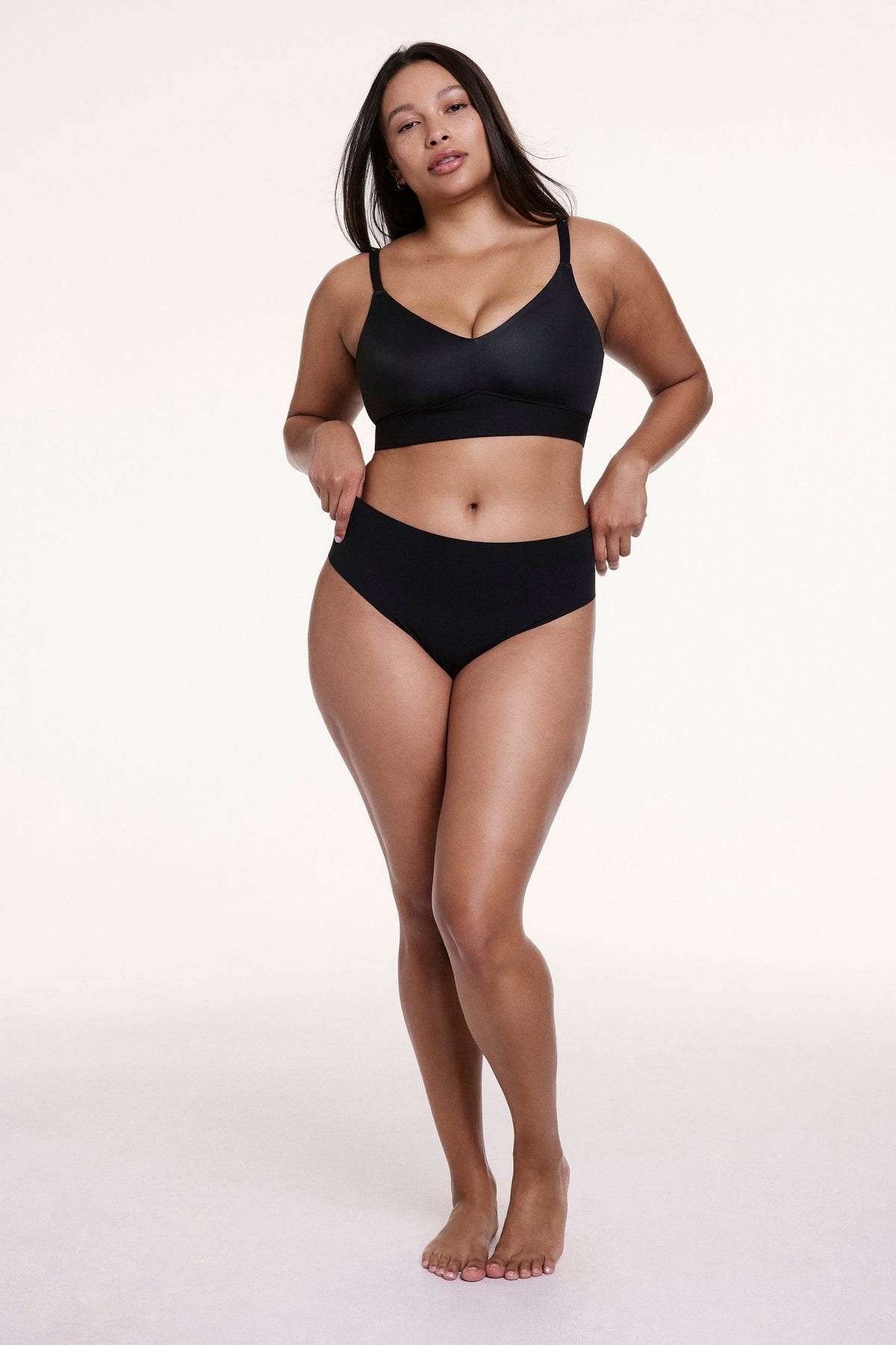 Full-body view of Alana wearing the No-Show High Waist Thong in Black with a matching bra, highlighting the smooth fit and no-show design.