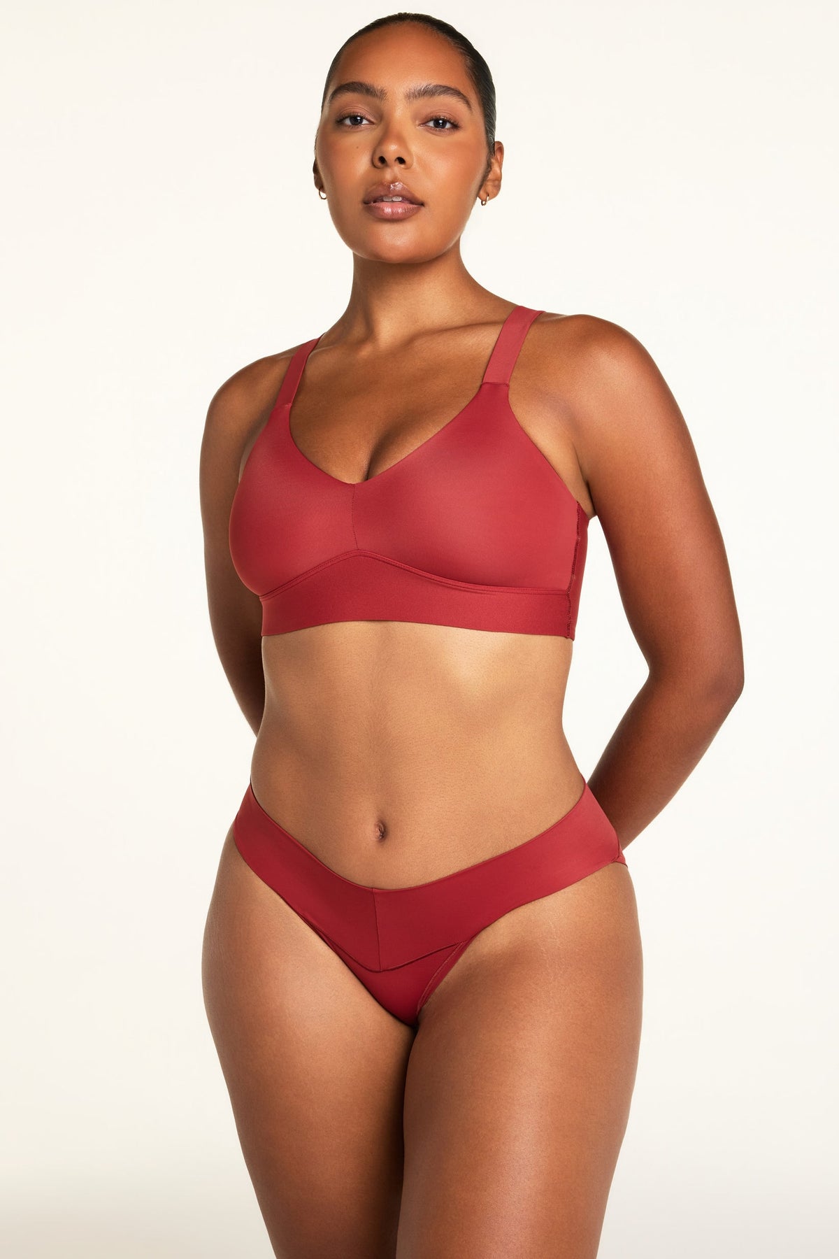 Three-quarter front view of the Bliss Low Rise Bikini in Ruby paired with the BlissSmooth Bralette in Ruby.